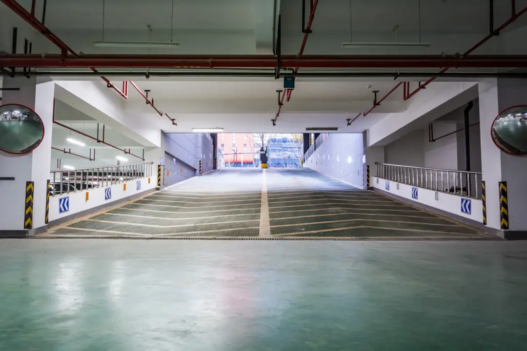 A parking garage entrance with a traffic barrier